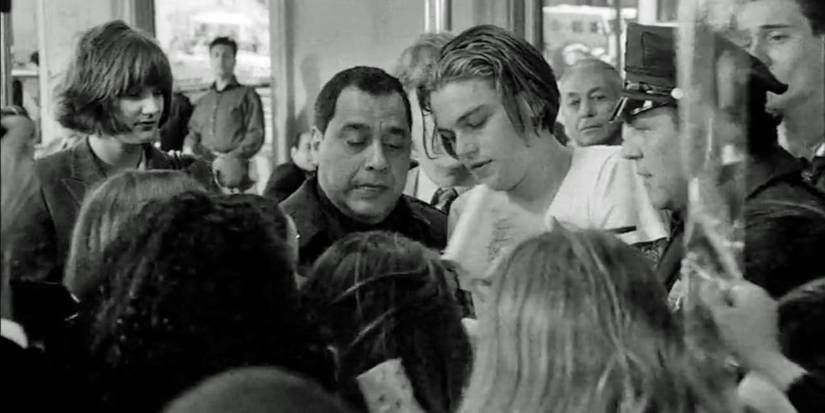 Leonardo DiCaprio surrounded by a crowd of fans in 'Celebrity' (1998).