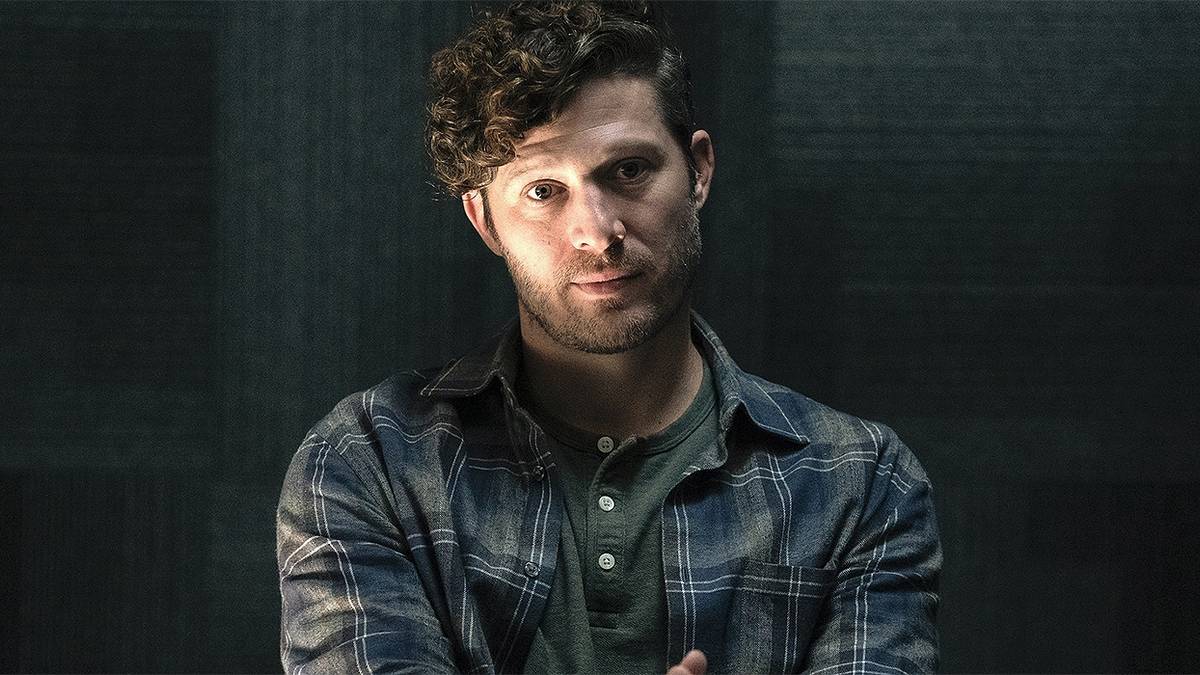 Zach Gilford as Sicarius sitting and looking off in the distance in Criminal Minds: Evolution