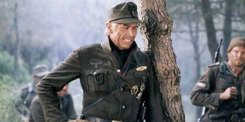 James Coburns' Steiner smiling against a tree in Cross of Iron