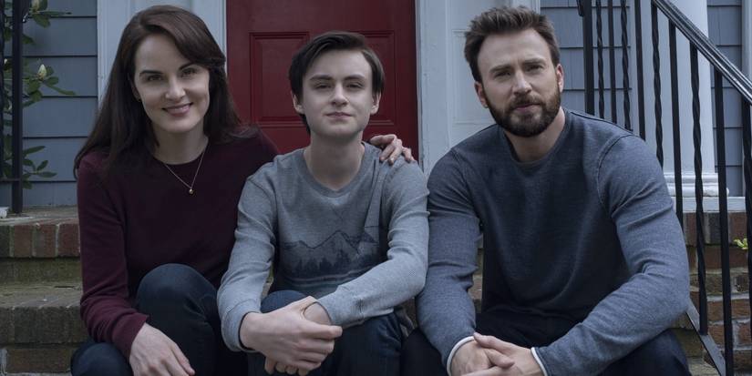 Laurie (Michelle Dockery), Jacob (Jaeden Martell), and Andy (Chris Evans) sit on a stoop outside a home in Defending Jacob.