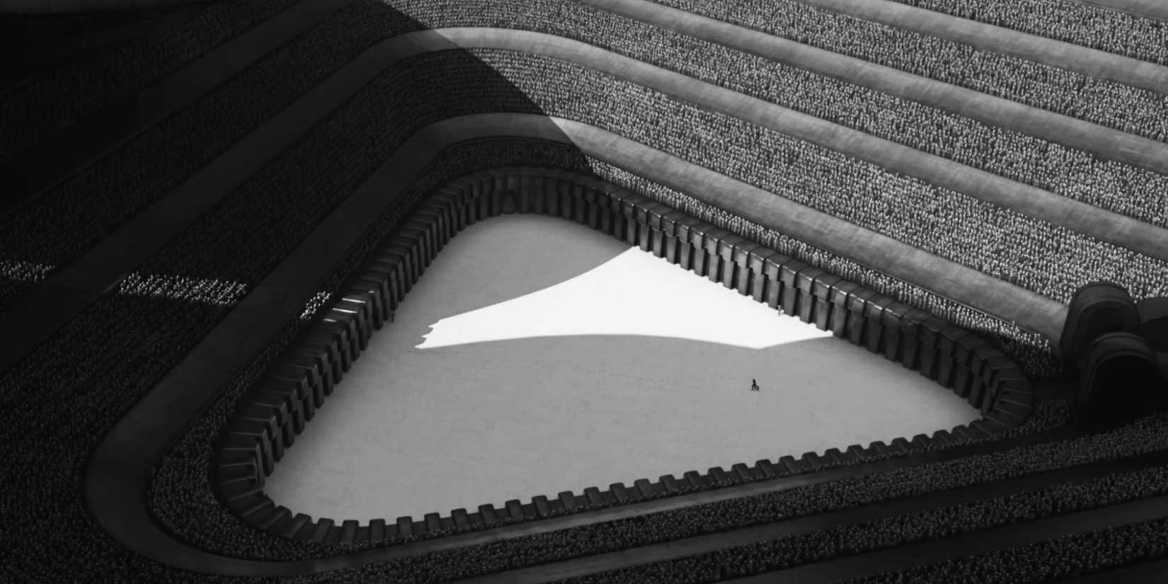 Ariel shot of a crown in an arena on the Harkonnen Planet in Dune Part Two