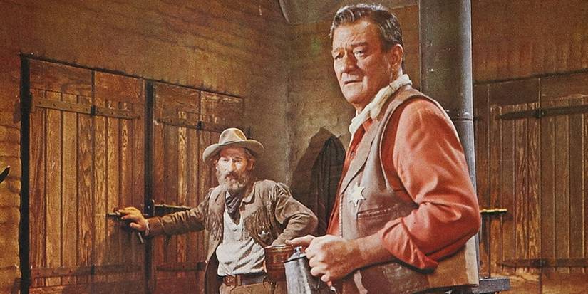 Arthur Hunnicutt as Bull Harris standing next to John Wayne as Cole Thornton in El Dorado