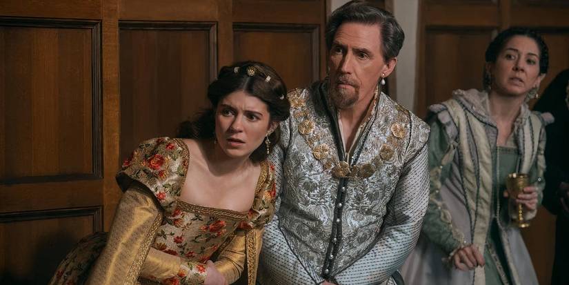 Jane and Lord Dudley leaning forward to look at something with concerned expressions in My Lady Jane