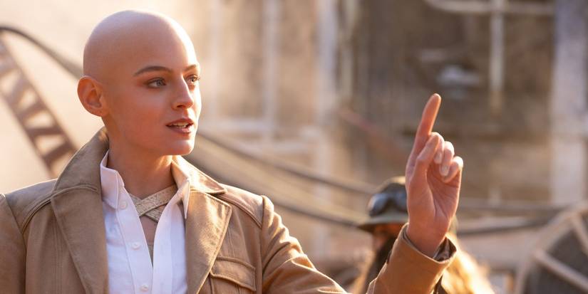 Emma Corrin as Cassandra Nova in Deadpool & Wolverine, holding up their index finger.