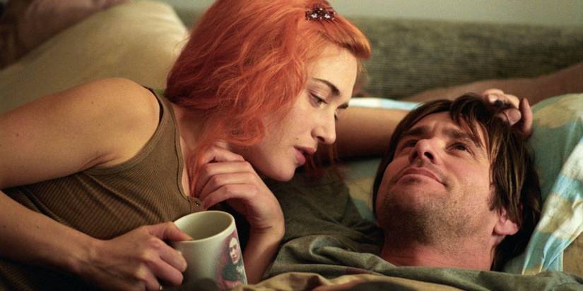 Joel and Clementine cuddling in bed together in Eternal Sunshine of the Spotless Mind.
