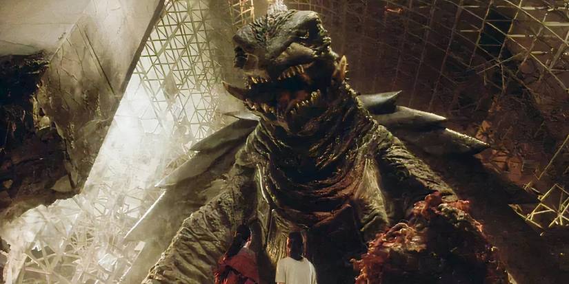 Gamera roaring at two figures in Gamera 3 Revenge of Iris