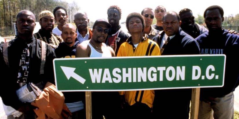 Get on the Bus cast stands behind a street sign for Washington D.C.