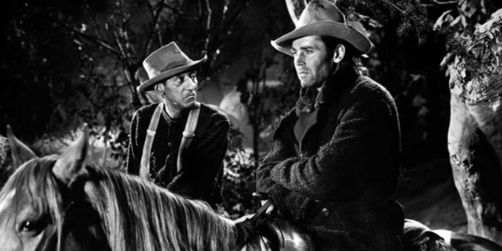 Henry Fonda and Leigh Whipper sitting on horses standing next to each other in The Ox-Bow Incident (1943)