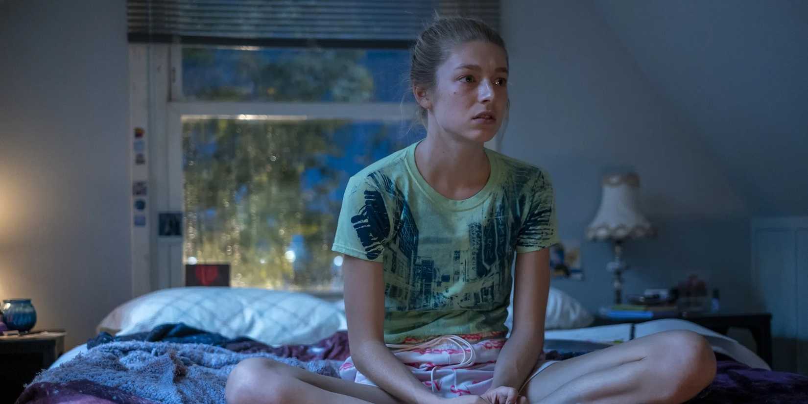 Hunter Schafer as Jules Vaughn in ‘Euphoria’ looking dejected while sitting cross legged on her bed