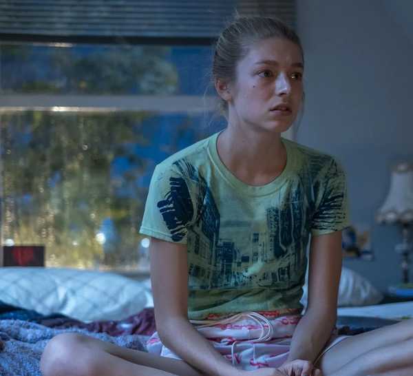 Hunter Schafer as Jules Vaughn in ‘Euphoria’ looking dejected while sitting cross legged on her bed