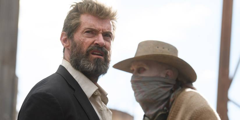 Hugh Jackman's Logan looking ahead, with Stephen Merchant's Caliban behind him in Logan.