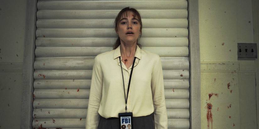 Maika Monroe stands with her back against a blood-spattered wall in Longlegs.