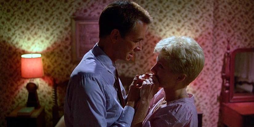 Maureen Coyle and Norman Bates clasped together romantically in Psycho 3.