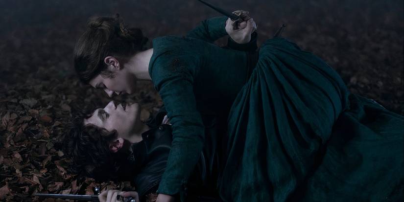 Jane Grey on top of Guildford Dudley while they lay on the ground in 'My Lady Jane'