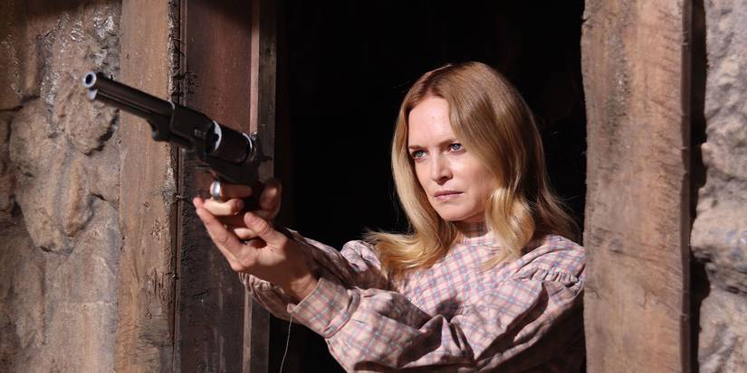 Heather Graham aiming a revolver in a doorway