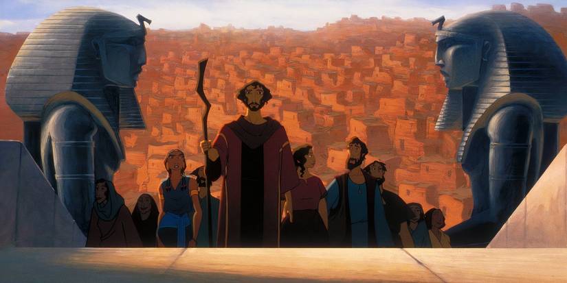Moses leads the Hebrews up stairs through a pair of busts of Pharaohs