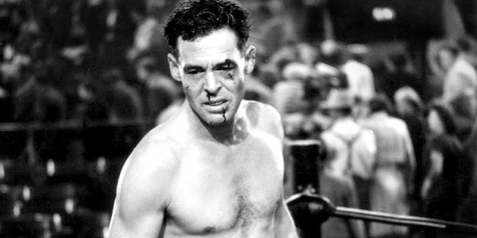 Robert Ryan as Bill with a bloody face inside a boxing ring in The Set-Up.