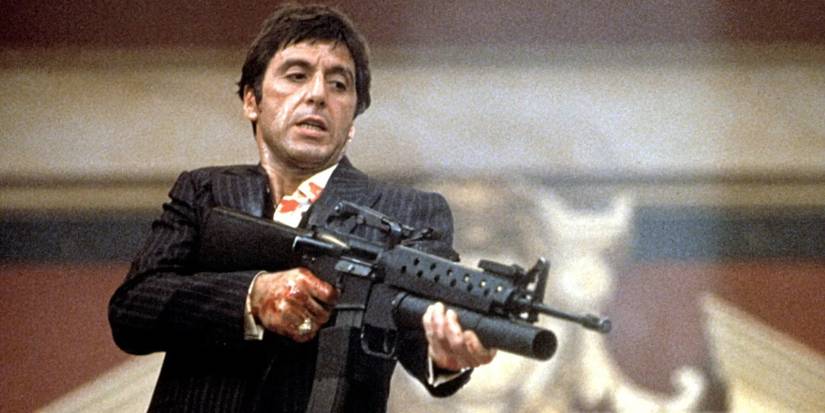 Al Pacino as Tony Montana shooting a rifle in 'Scarface'.