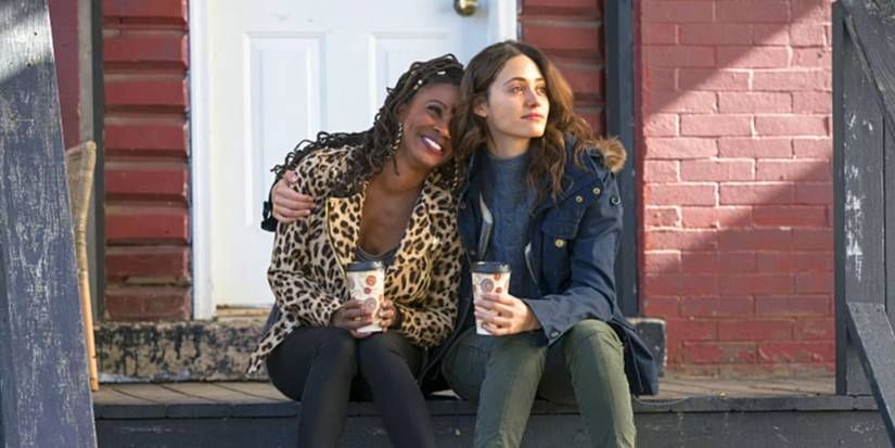 Veronica "V" Fisher (Shanola Hampton) and Fiona Gallagher (Emmy Rossum) sit next to each other on the front porch