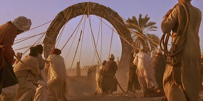 A group of workers set up the Stargate using ropes 