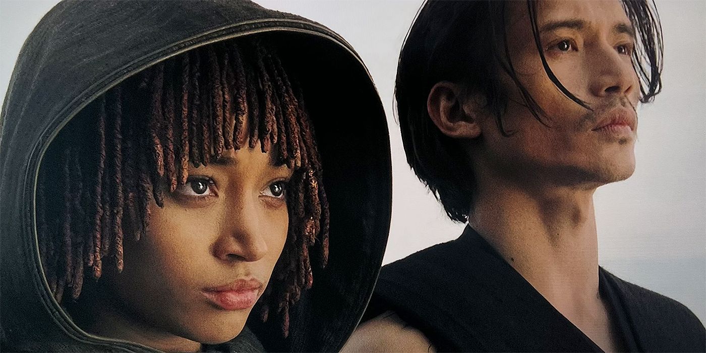Amandla Stenberg as Osha and Manny Jacinto as Qimir standing side by side looking at the ocean in The Acolyte finale