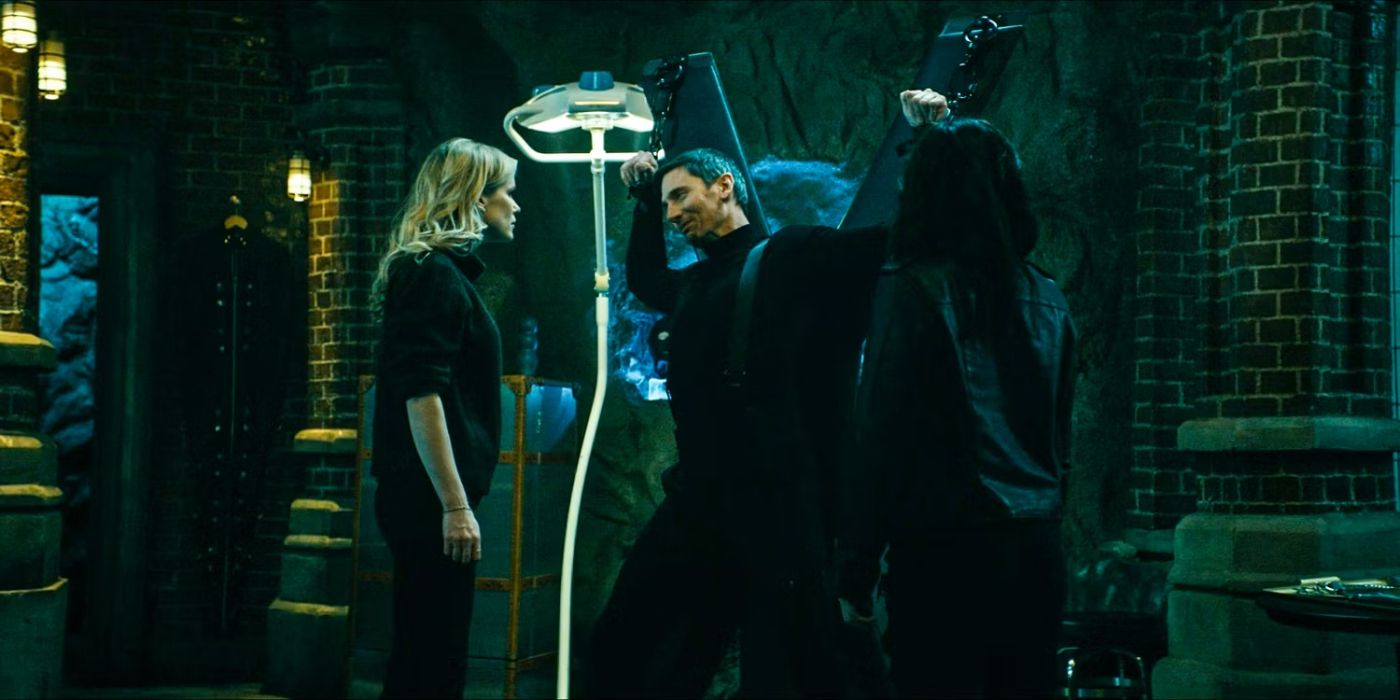 Tek Knight (Derek Wilson) is chained to a BDSM device in his dungeon while Starlight (Erin Moriarty) and Kimiko (Karen Fukuhara) interrogate him in 'The Boys'.