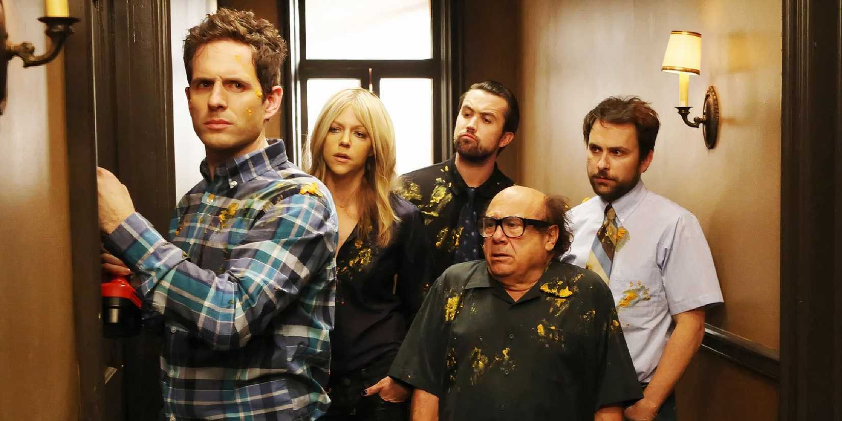 The cast of 'It's Always Sunny in Philadelphia' standing in a hallway