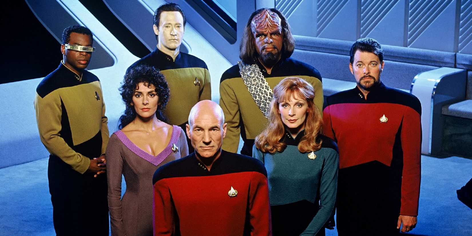 The cast of Star Trek The Next Generation looks up at the camera in a promotional shoot.