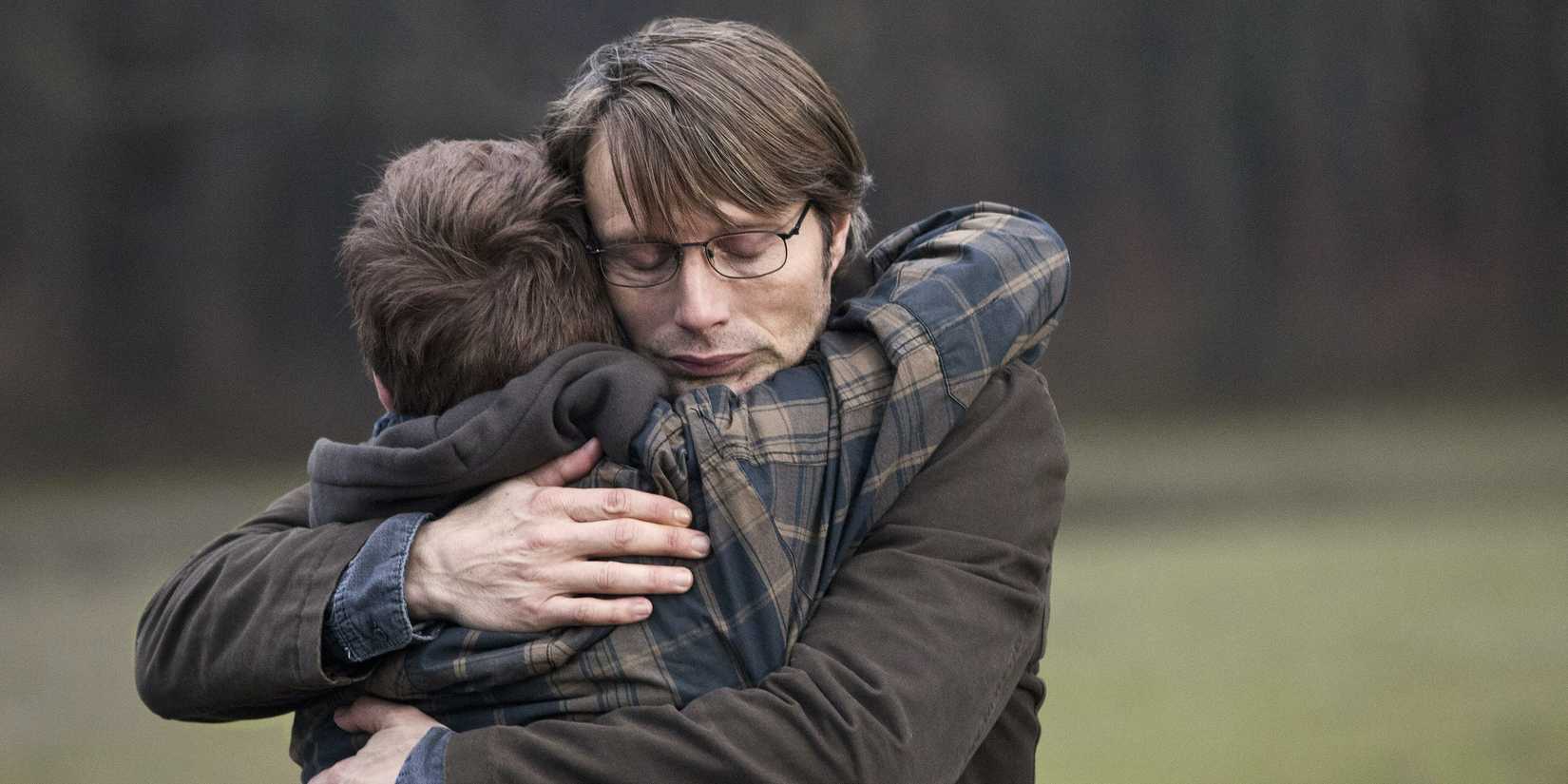 Mads Mikkelsen as Lucas hugs his son, Lasse Fogelstrøm as Marcus, in The Hunt (2012)