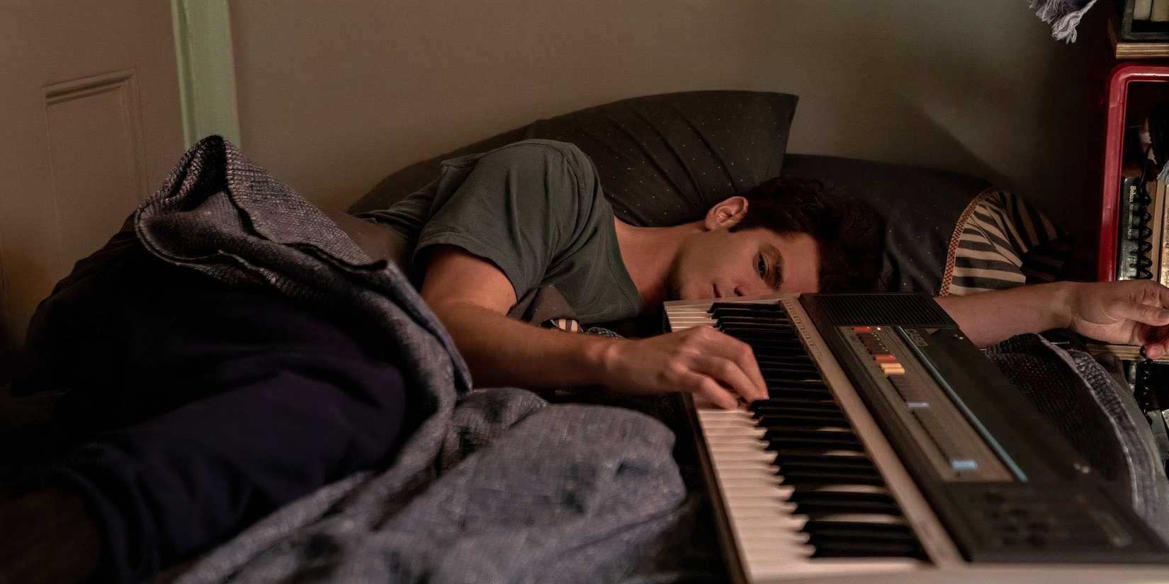 Jonathan Larson (Andrew Garfield) falls asleep at his keyboard in 'Tick, Tick... Boom!' (2021)