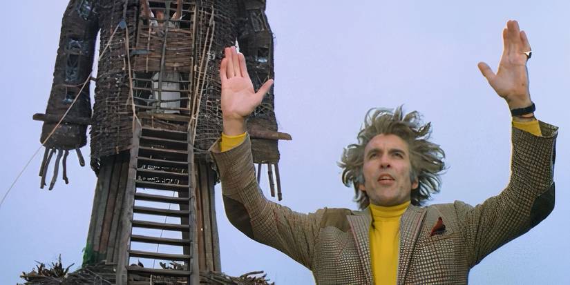 Lord Summerisle prays in front of the eponymous Wicker Man in The Wicker Man.