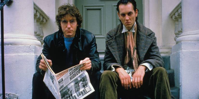Marwood (Paul McGann) reads the newspaper next to Withnail (Richard E. Grant) in Withnail and I 