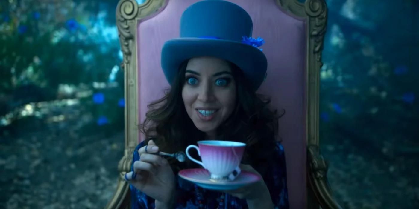 Aubrey Plaza wears a top hat and holds a teacup with wide crazy eyes in FX's Legion.