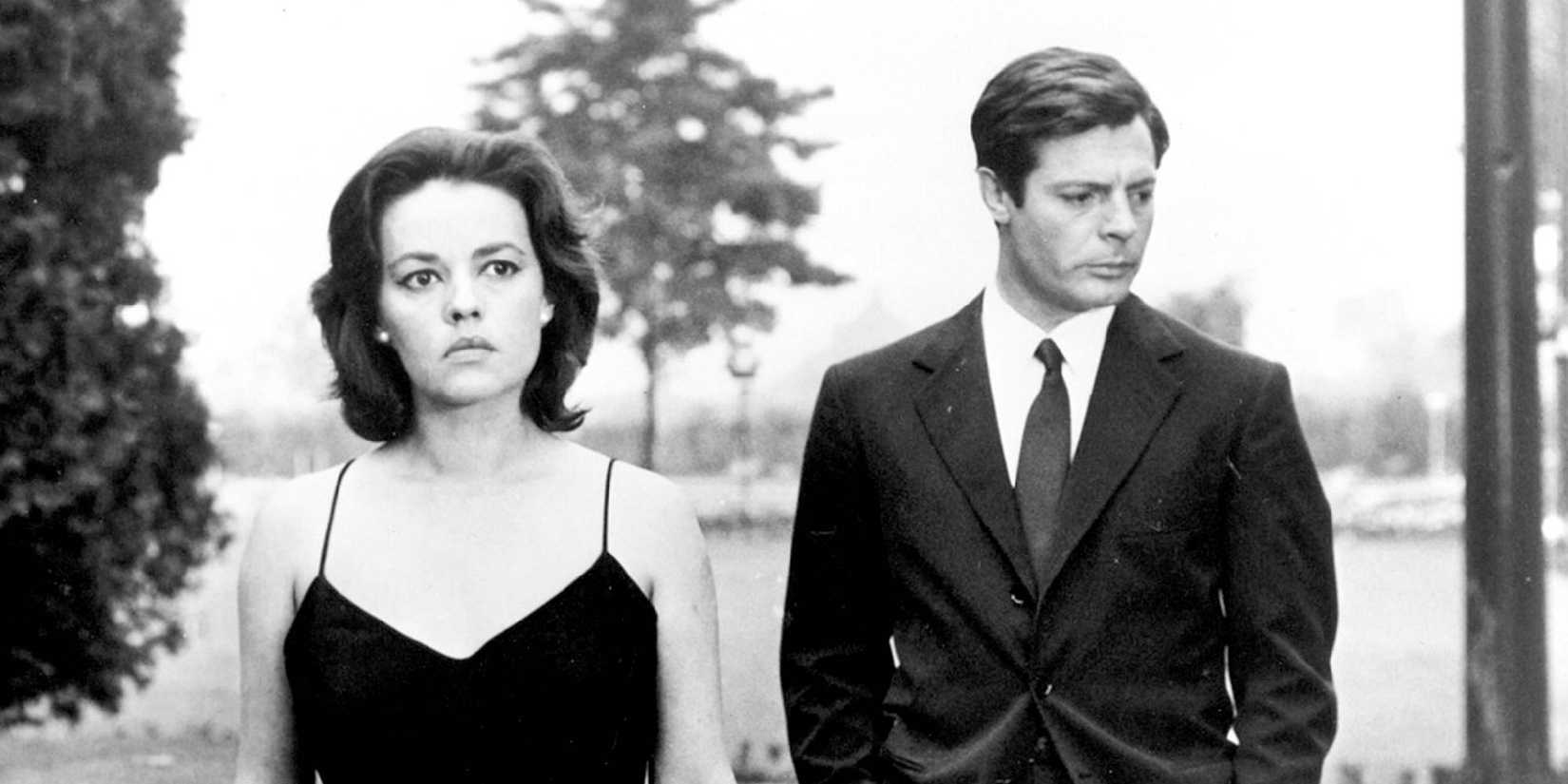 A man and woman walk side by side in La Notte