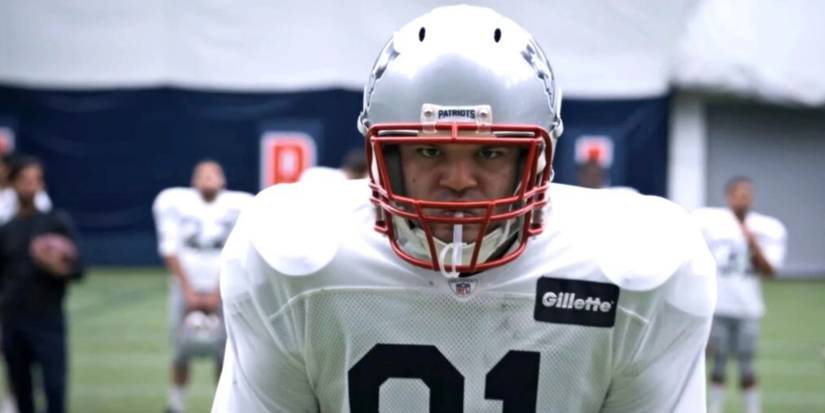 Aaron Hernandez (Josh Rivera) in football helmet and uniform in a scene from 'American Sports Story: Aaron Hernandez.'