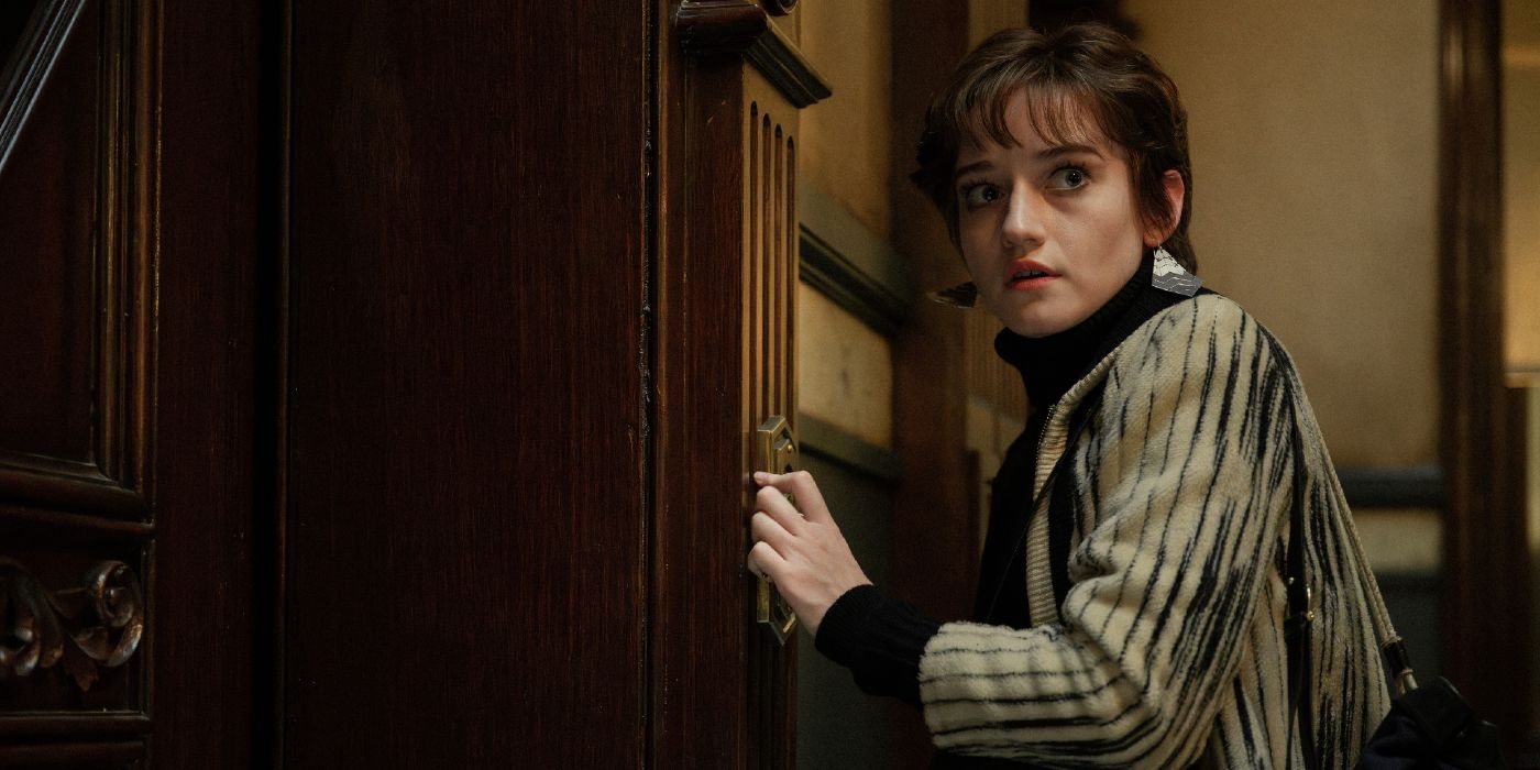 Julia Garner looks fearfully over her shoulder in Apartment 7A