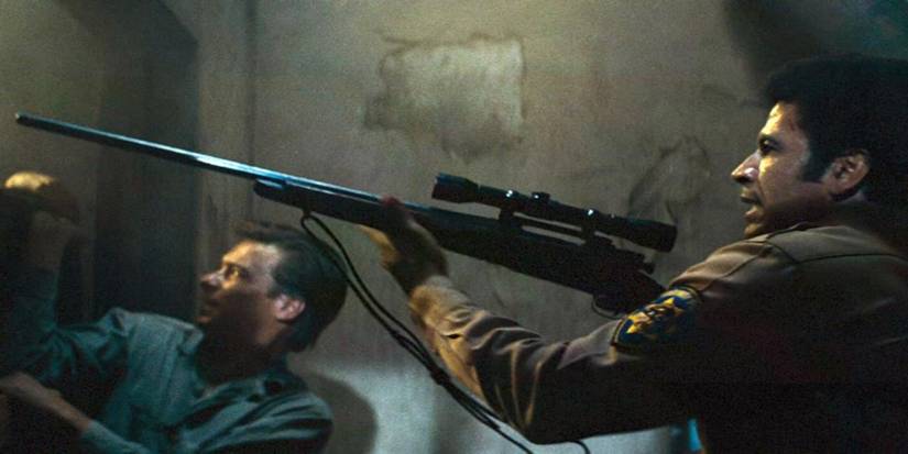 A man aims a rifle ahead in Assault on Precinct 13