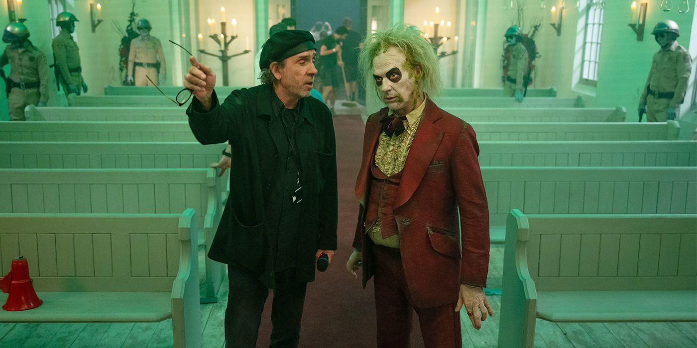 Tim Burton directing Michael Keaton on the set of Beetlejuice 2 between pews of a church