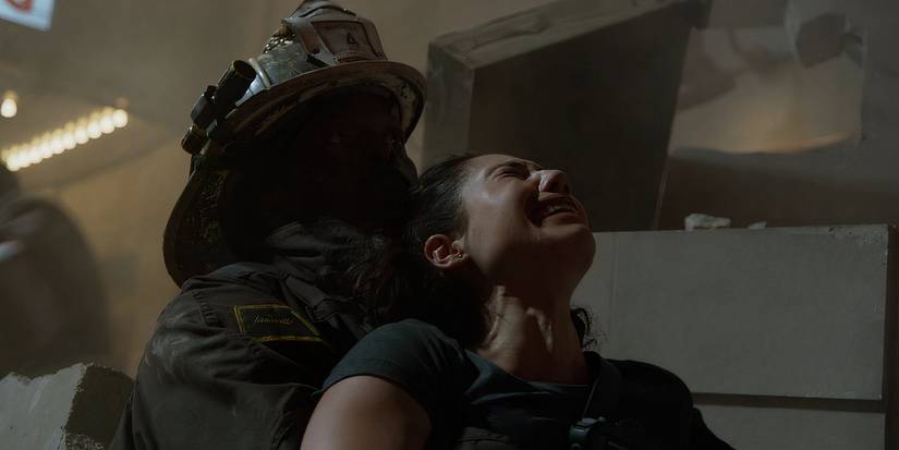 Eamonn Walker as Chief Boden in a fireman's suit holding Hanako Greensmith as Violet Mikami who is crying in Chicago Fire.