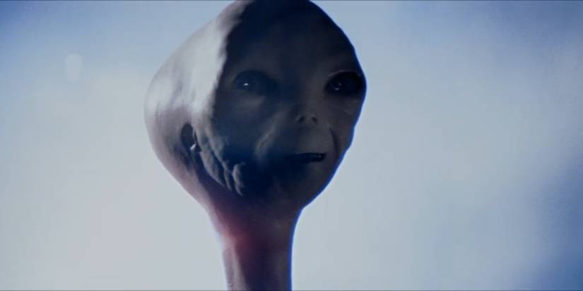 An alien smiles in Close Encounters of the Third Kind​​​​​​​.