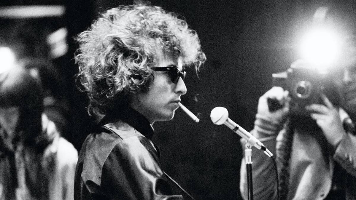 Bob Dylan performing while a camera flashes in Don't Look Back