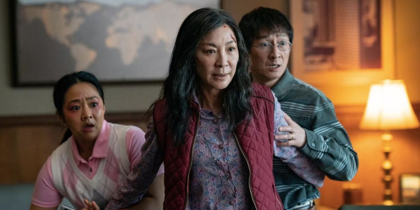 Stephanie Hsu, Michelle Yeoh, and Ke Huy Quan stand together looking scared in Everything Everywhere All at Once.