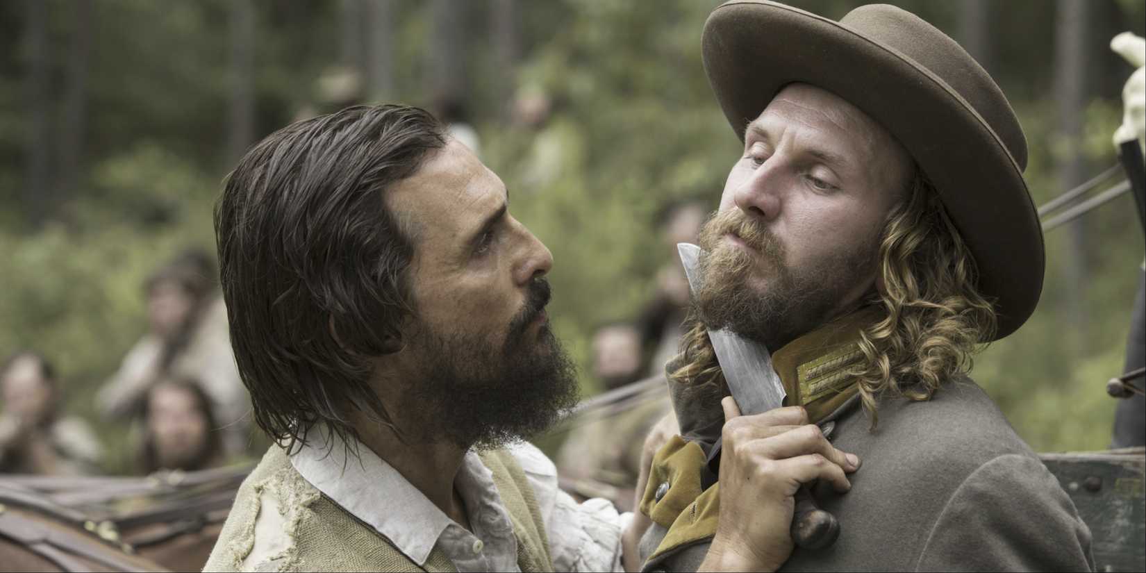 Matthew McConaughey holds a knife up to a man's throat in Free State of Jones.