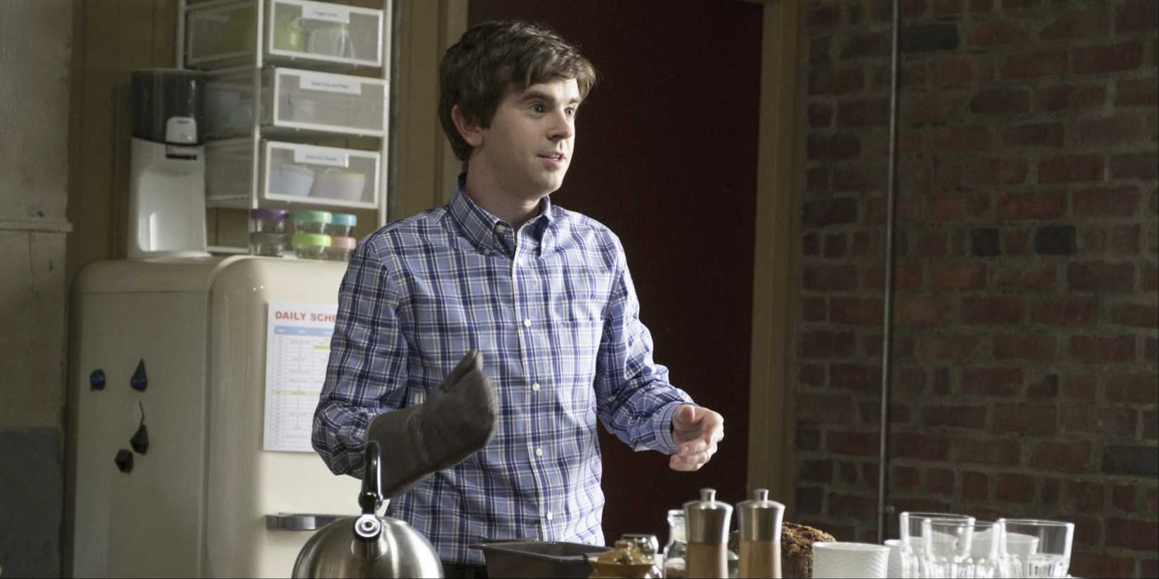 Shaun Murphy looking surprised as he gets food out of the oven in The Good Doctor