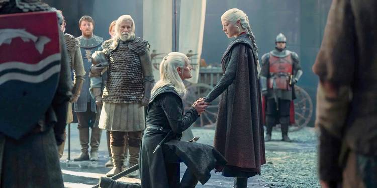 Daemon Targaryen kneels in front of Rhaenyra Targaryen holding her hand in House of the Dragon Season 2.