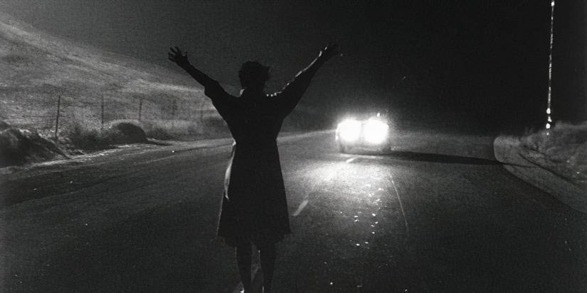 A woman stopping a car at night in 'Kiss Me Deadly'