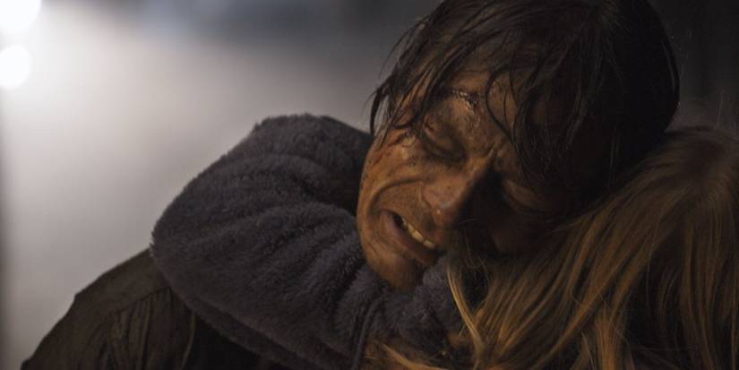 Kristian holding and hugging his wife, sobbing, The Wave