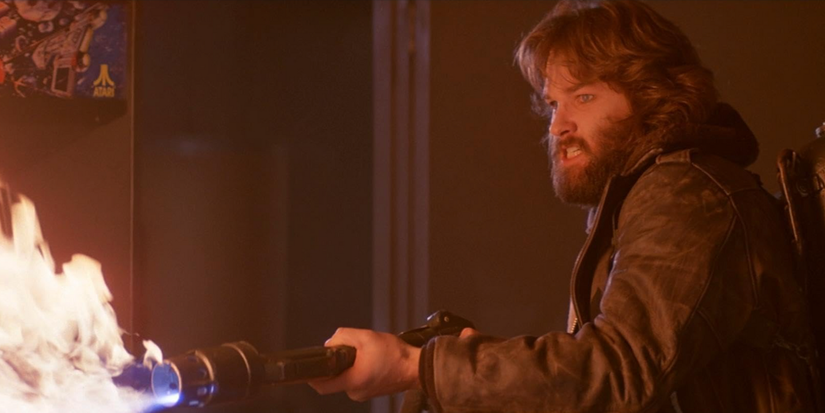 Kurt Russell using a flamethrower in The Thing (1982).
