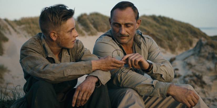 Land of Mine Land of Mine Louis Hofmann and Roland Møller seated