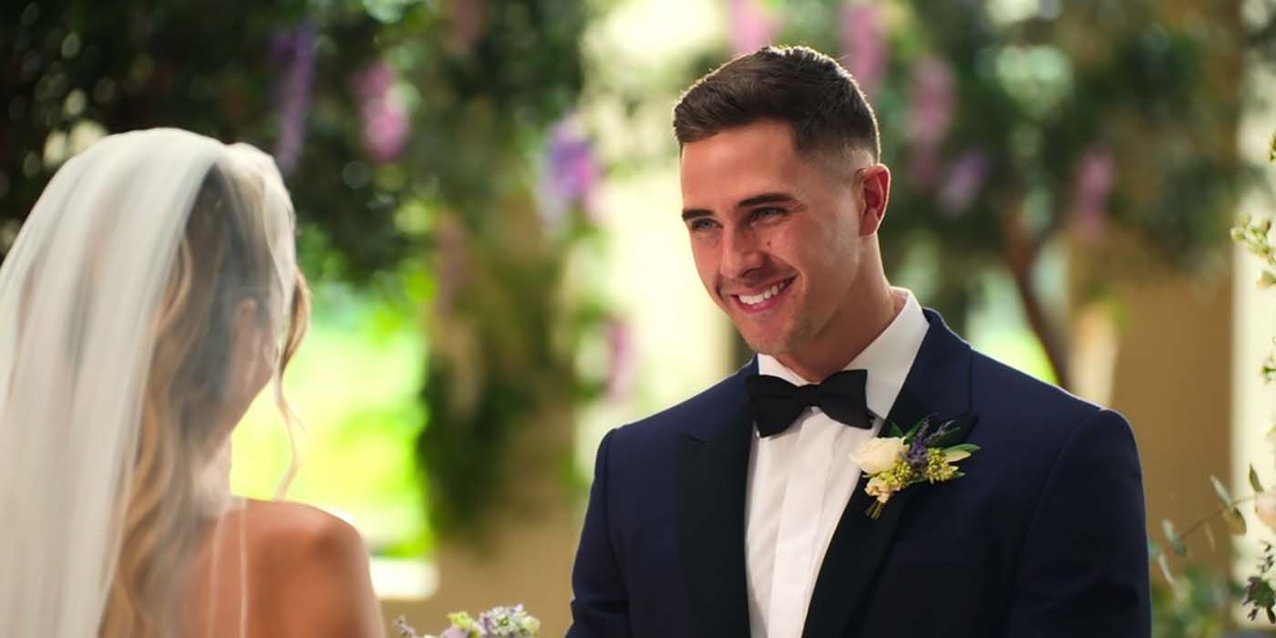 Freddie in a tuxedo smiling while looking at Catherine in a scene from Love is Blind: UK